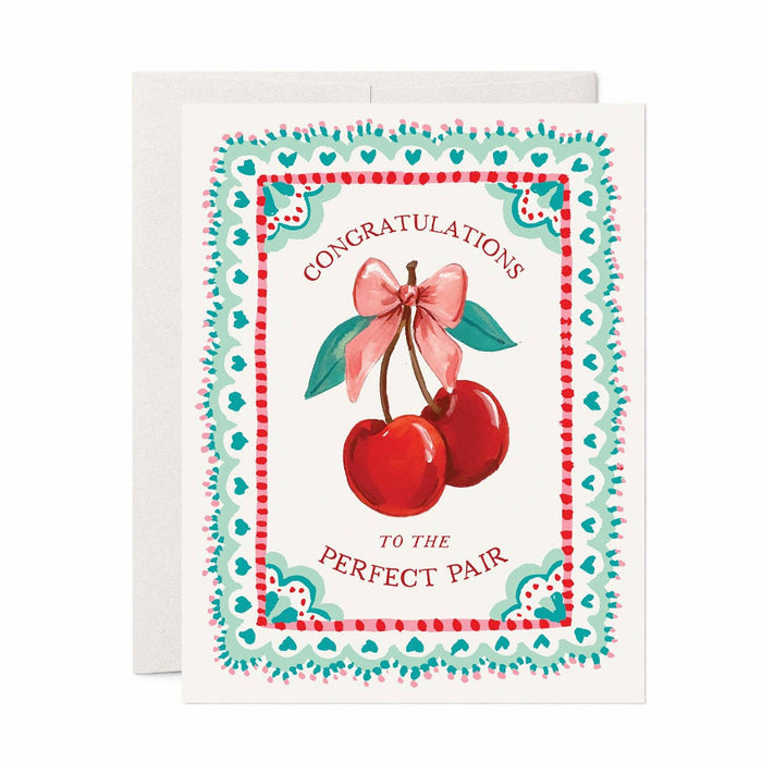 Greeting card with cherries and a bow, featuring text 'Congratulations to the perfect pair'.