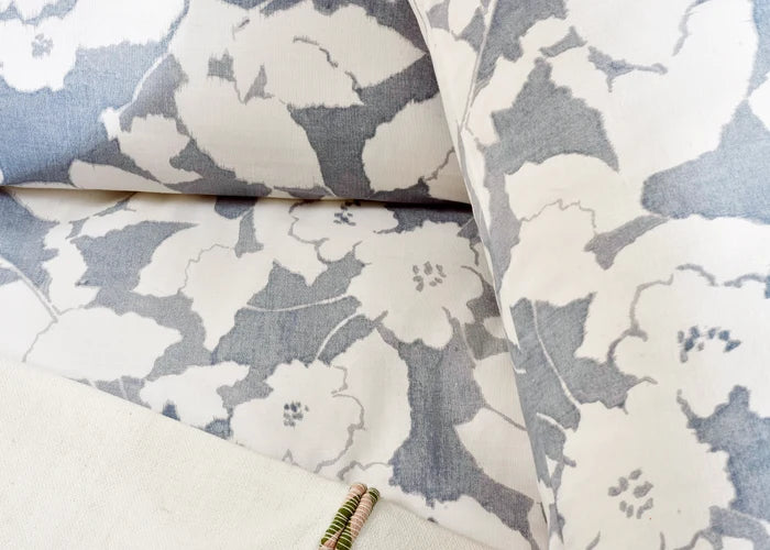 Close-up of blue and white floral cotton sateen duvet cover fabric with stitching