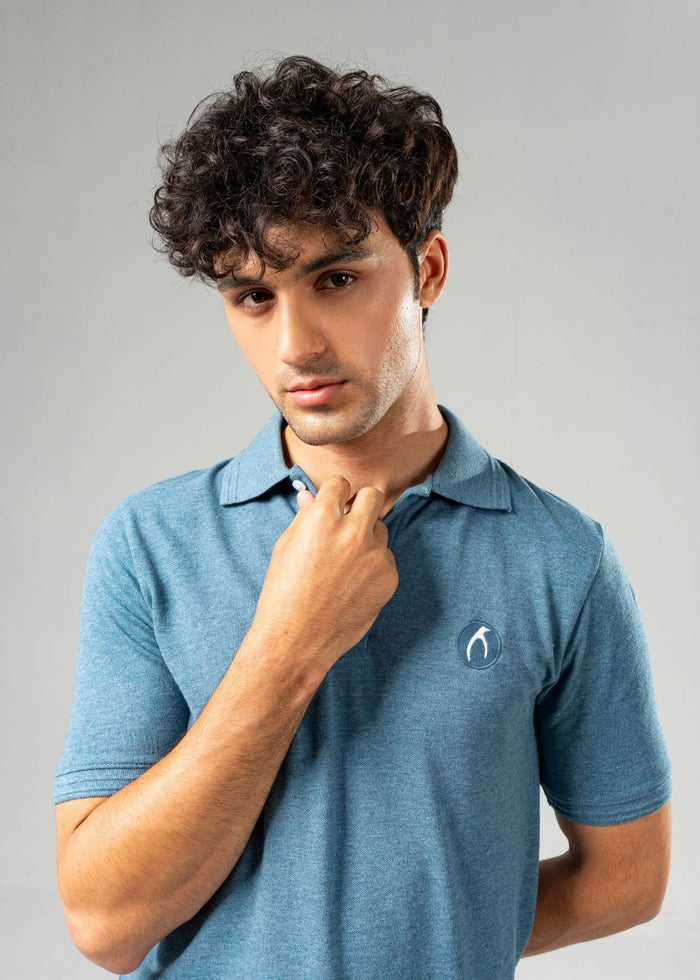 Men's blue polo shirt with short sleeves, button placket, and chest logo at collar