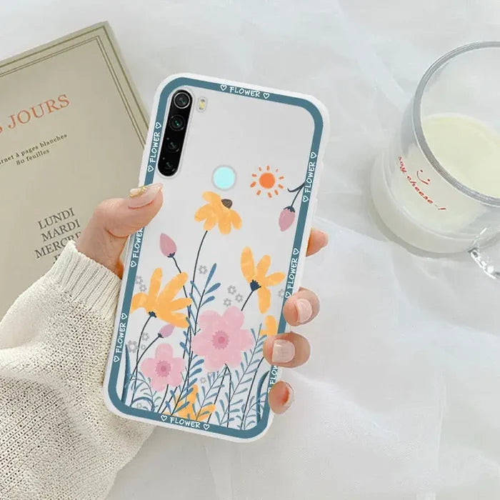 a woman holding a phone case with flowers on it