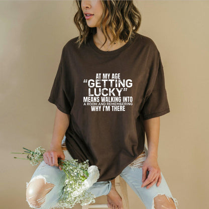 "At My Age Getting Lucky" Funny T-Shirt – Sarcastic Aging Humor Graphic Tee, Unisex Cotton Shirt - Teezioo