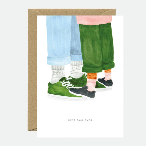 Illustration of a father and child standing together with green shoes, wearing 'Best Dad' socks, on a white background.