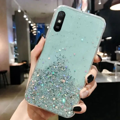 a woman holding a phone case with glitter on it