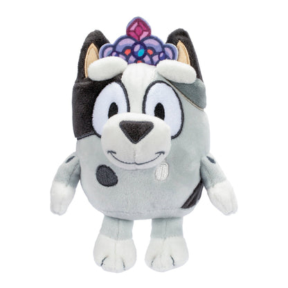 The Bluey & Friends Plushie by Moose Toys features a gray cartoon dog with black spots, a jeweled purple and pink crown, big eyes, a smiling face, and white arms and legs—perfect for fans of Bluey plush toys.