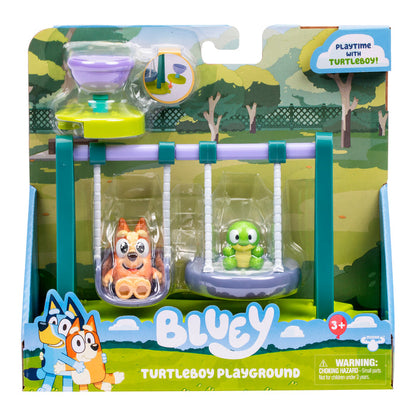 Bluey and Bingo hug on the Bluey Mini Playset & Figures packaging by Moose Toys, which includes collectible playsets with Bluey and Turtleboy figures on swings and a purple and green hourglass toy.