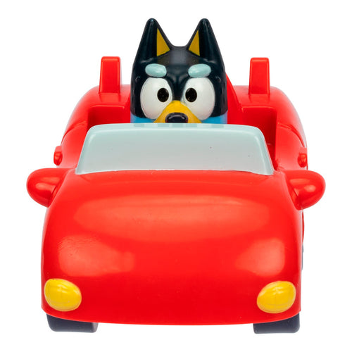 A Black-furred cartoon dog figure with yellow eyebrows sits facing forward in a bright red Bluey Mini Racers convertible from Moose Toys, featuring yellow headlights and side mirrors—ideal for collectors and fans of toy cars.