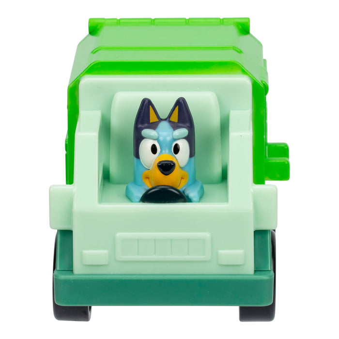 A small toy truck from Moose Toys, Bluey Mini Racers, featuring a green cab and a cartoon blue dog character driving, viewed from the front.