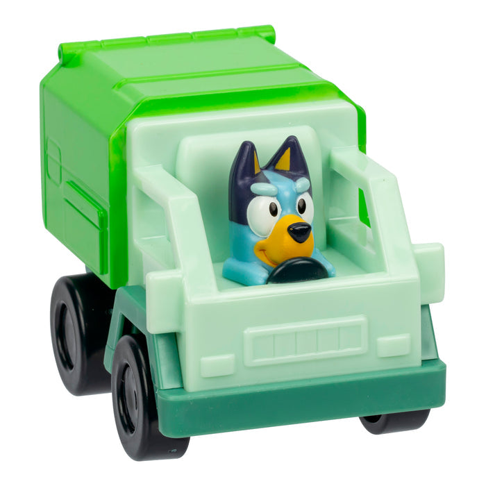 The Bluey Mini Racers by Moose Toys features a blue dog with a focused look driving a green garbage truck, inspired by the children’s show Bluey—perfect for imaginative play and collecting.