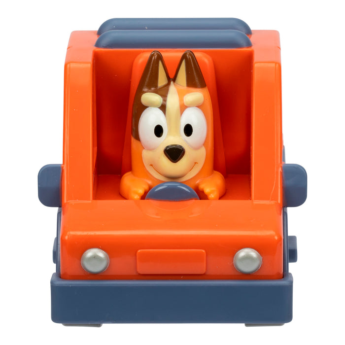 The Moose Toys Bluey Mini Racers collectible features a smiling cartoon dog with brown ears driving an orange and blue car, viewed from the front with the dog holding the steering wheel.