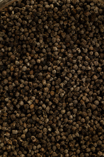 Close-up of dark brown peppercorns