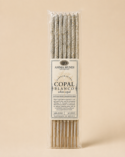 A package of Anima Mundi White Copal incense sticks, featuring a clear plastic sleeve with a central cream-colored paper label, set against a solid beige background.