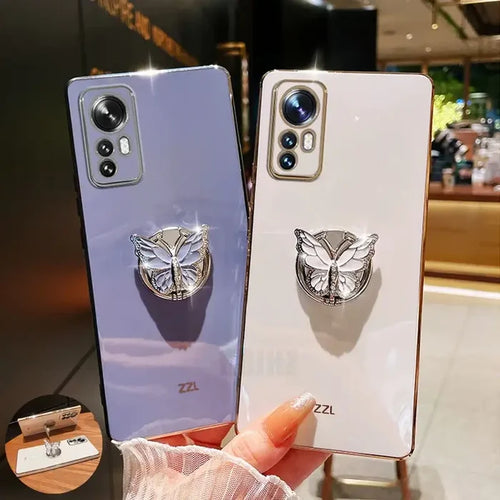 two iphone cases with a silver ring on top