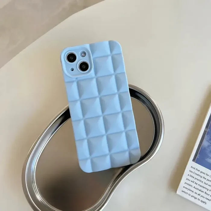 A cell case sitting on top of a metal can