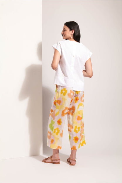 Woman wearing Foil Fo8341 Cut Of Your Rib Top White, styled with floral pants, shop Foil at Dotique for chic fashion.