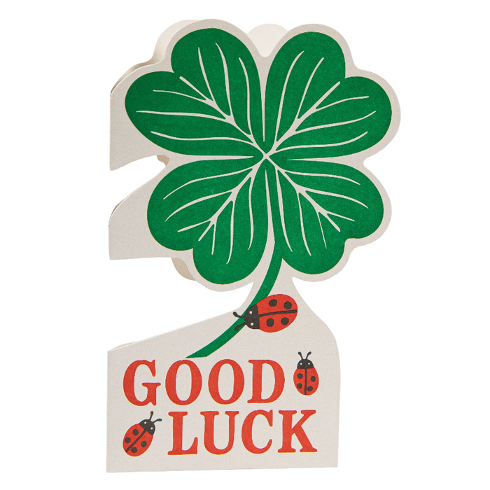 Four-leaf clover with 'Good Luck' text and ladybugs on a white background