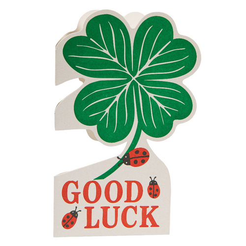 Four-leaf clover with 'Good Luck' text and ladybugs on a white background