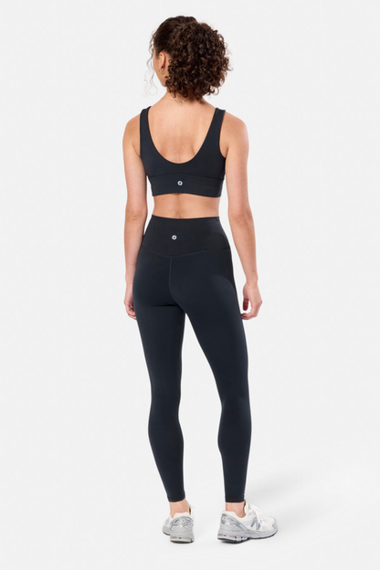 Woman wearing Gym + Coffee Soft-Motion Bra Black by Gym+Coffee with leggings, shop Gym+Coffee at Dotique for activewear.