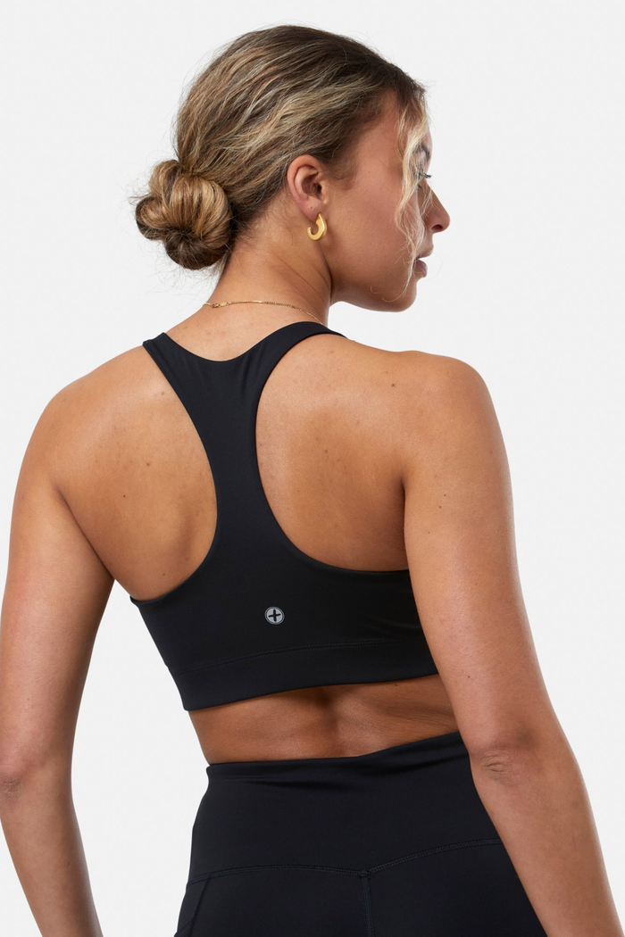 Athletic woman wearing Gym+Coffee Relentless Bra Black from Gym+Coffee, shop Gym+Coffee at Dotique.