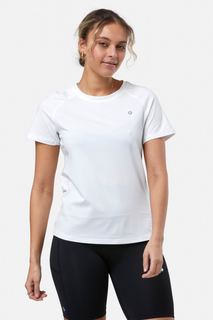 Woman wearing Gym+Coffee Relentless Tee in Ultra White by Gym+Coffee shop the brand at Dotique for performance wear.