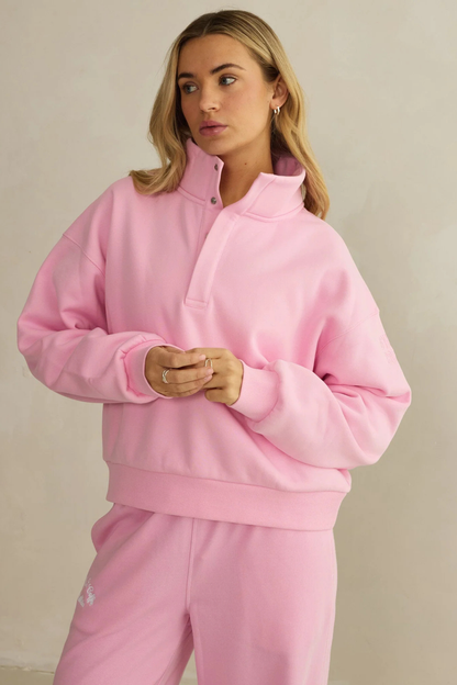 Model wearing Gym+Coffee Snap Collar High Waist Sweatshirt Pink Blossom by gym+coffee, shop gym+coffee at Dotique in soft pink tone