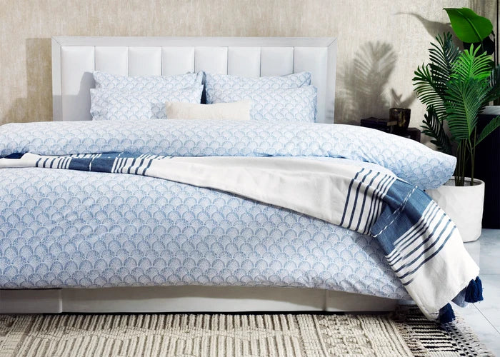 6-piece duvet cover set on bed, light-blue fan print with striped accent throw