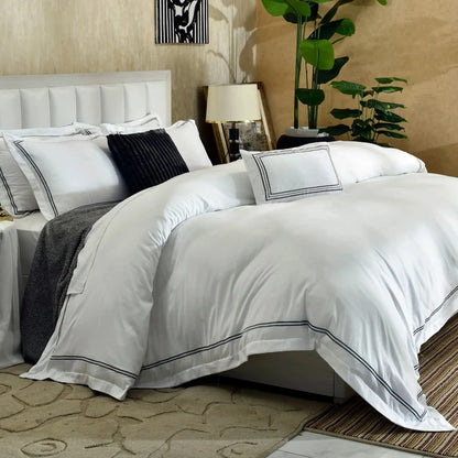White duvet cover set with black piped trim and dark navy textured pillows