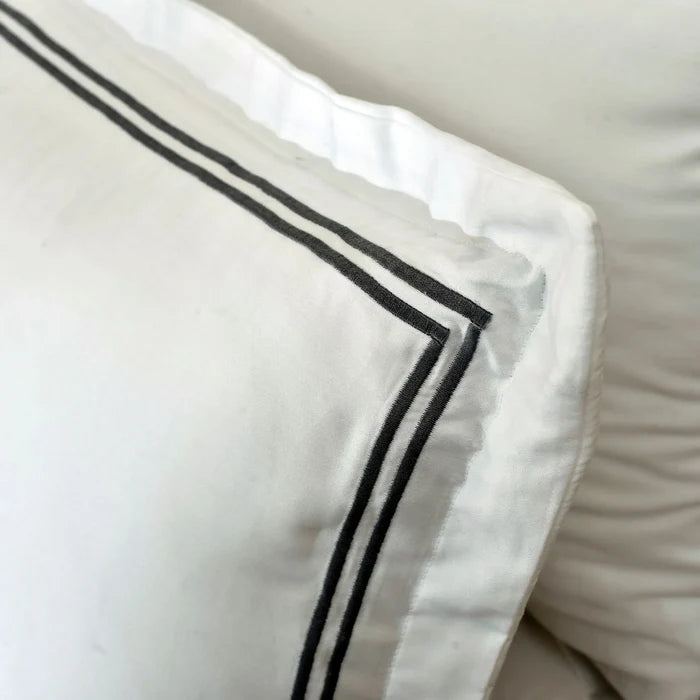 White duvet cover corner with double black stripe piping
