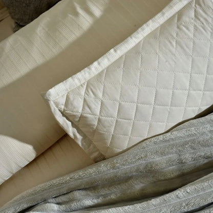 Cream cotton satin duvet cover with quilted diamond texture and stitched border