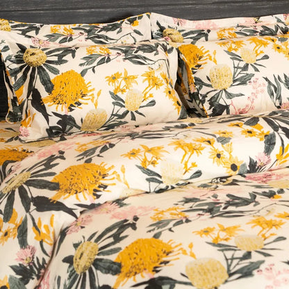 Floral pillowcases and duvet with cream base, yellow blooms and green stems