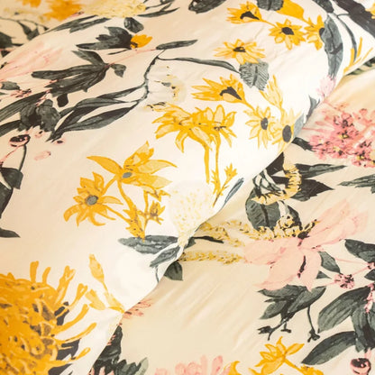 Floral bed set with cream duvet and pillowcases, yellow and pink blooms, green leaves