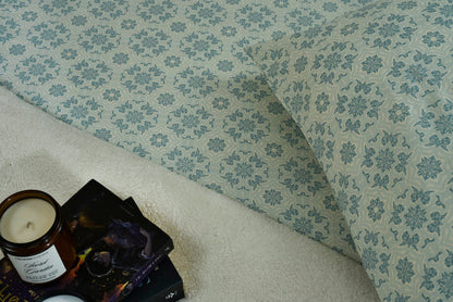 Ice blue cotton sateen bed sheet close-up with detailed floral damask pattern