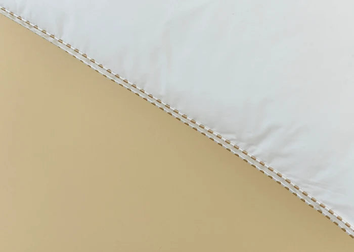 White pillow seam with beige piping and double stitching