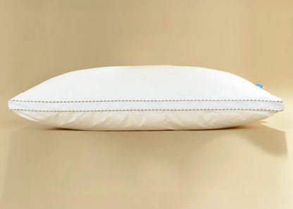 White filled pillow side view with piped edge and stitched border
