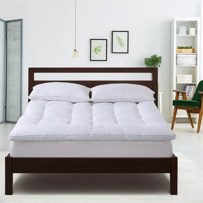 White queen mattress topper, quilted comfort layer with domed center seam detail.