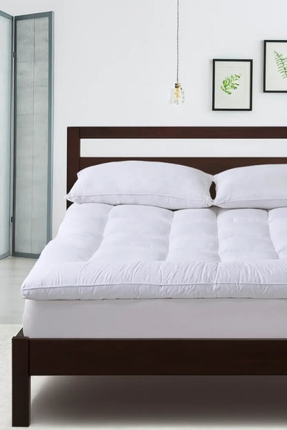 Queen mattress topper with white microfabric cover and plush polyester fill, quilted surface.