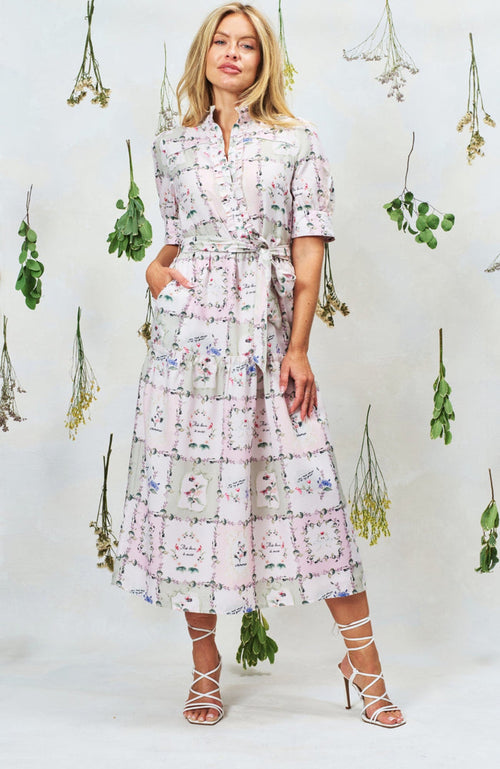 Woman wearing Hope & Ivy Pamela Tiered Maxi Dress in floral print, shop Hope and Ivy at Dotique for elegant style.