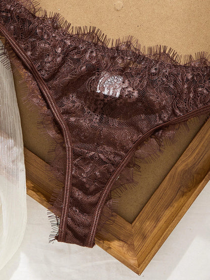 Brown lace lingerie on a wooden surface