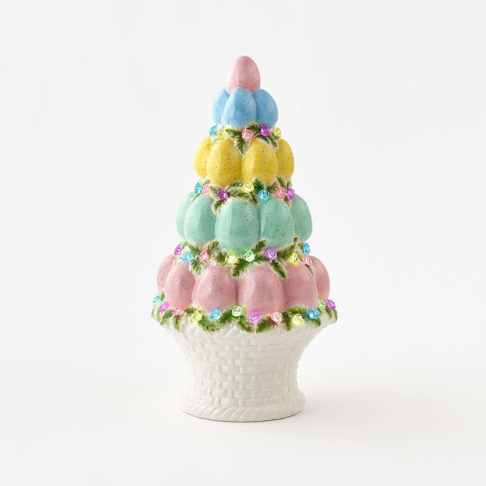 Decorative cake-shaped vase with pastel colors on a white background