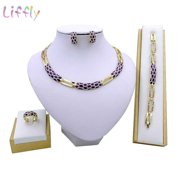 Luxury bridal gold jewelry set featuring geometric design with crystals. Includes necklace, earrings, bracelet and ring. Ideal for weddings and parties.