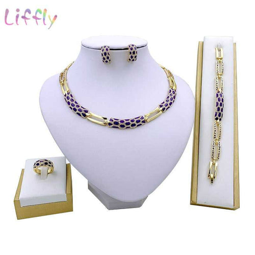 Luxury bridal gold jewelry set featuring geometric design with crystals. Includes necklace, earrings, bracelet and ring. Ideal for weddings and parties.