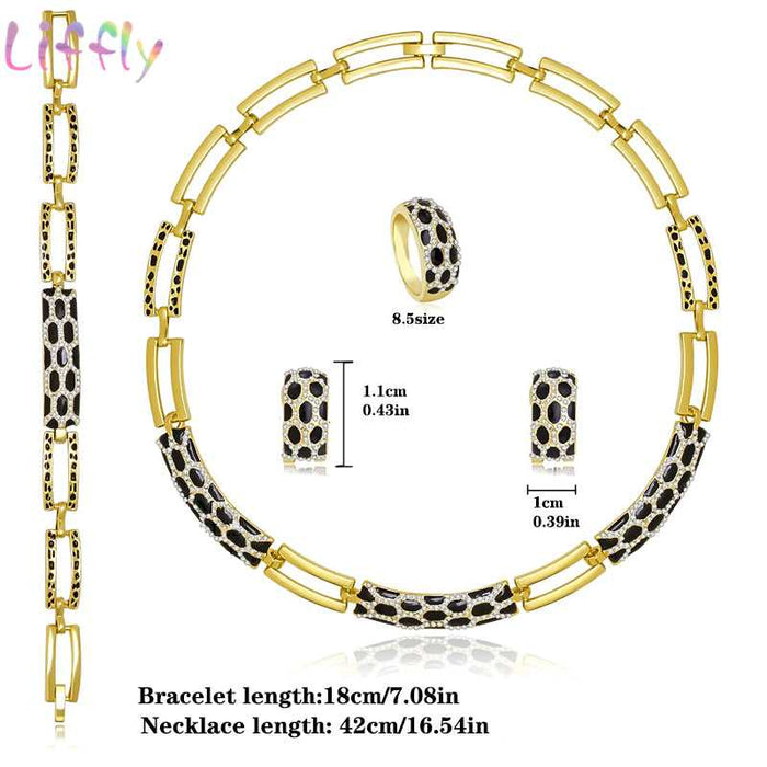 Luxury bridal gold jewelry set featuring geometric design with crystals. Includes necklace, earrings, bracelet and ring. Ideal for weddings and parties.