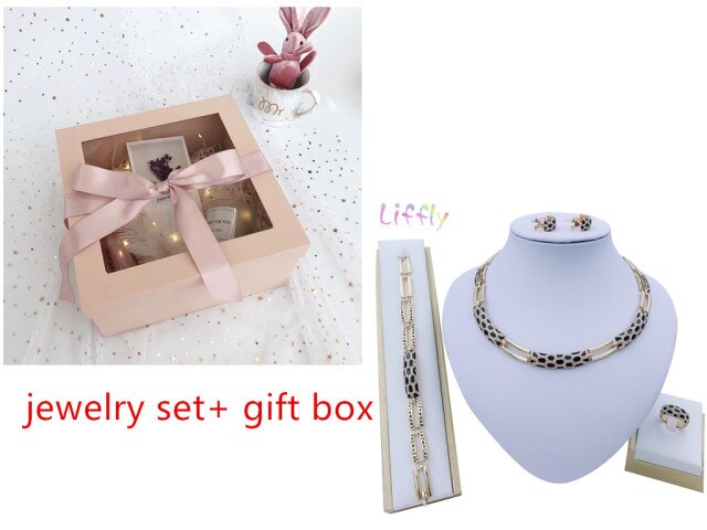 Luxury bridal gold jewelry set featuring geometric design with crystals. Includes necklace, earrings, bracelet and ring. Ideal for weddings and parties.