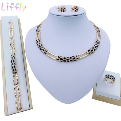 Luxury bridal gold jewelry set featuring geometric design with crystals. Includes necklace, earrings, bracelet and ring. Ideal for weddings and parties.