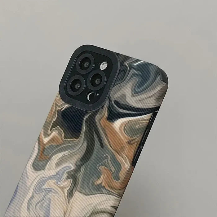 The back of a phone case with a painting on it