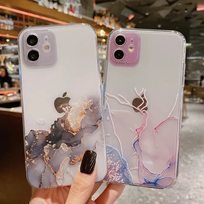 A woman holding a phone case with a marble pattern