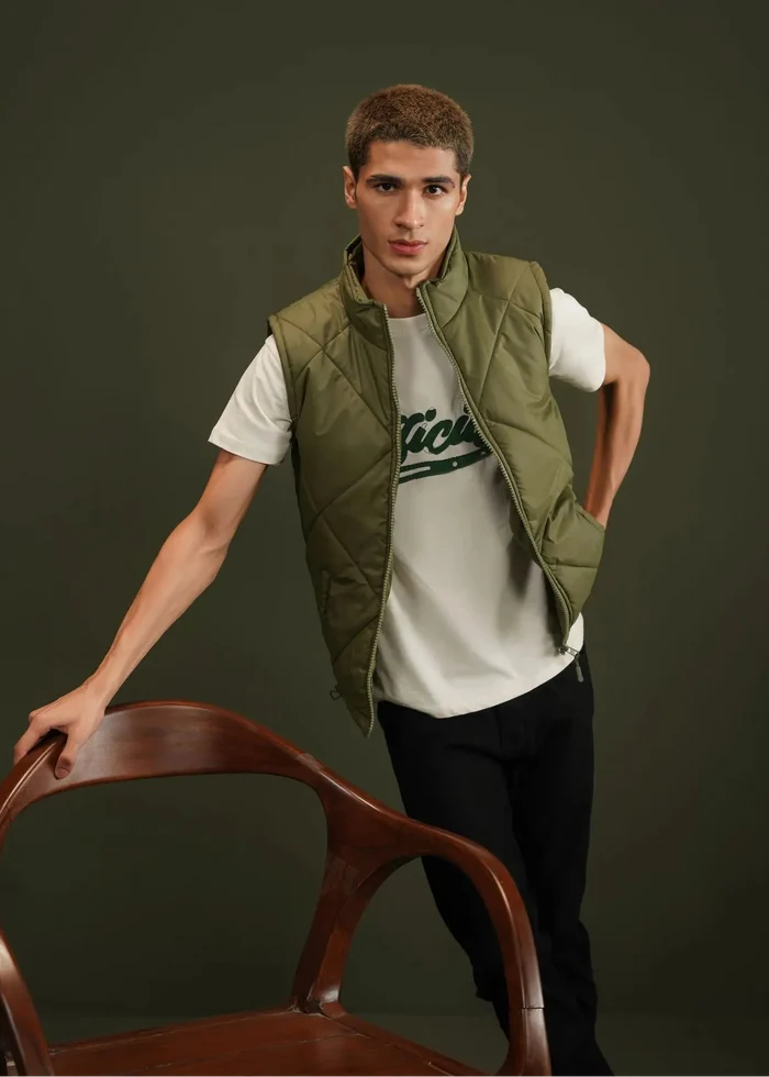 Men's olive quilted bubble vest close-up, stand collar and zip front