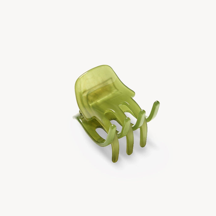 Green hair clip on a white background