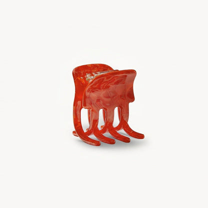 Red hair clip on a white background