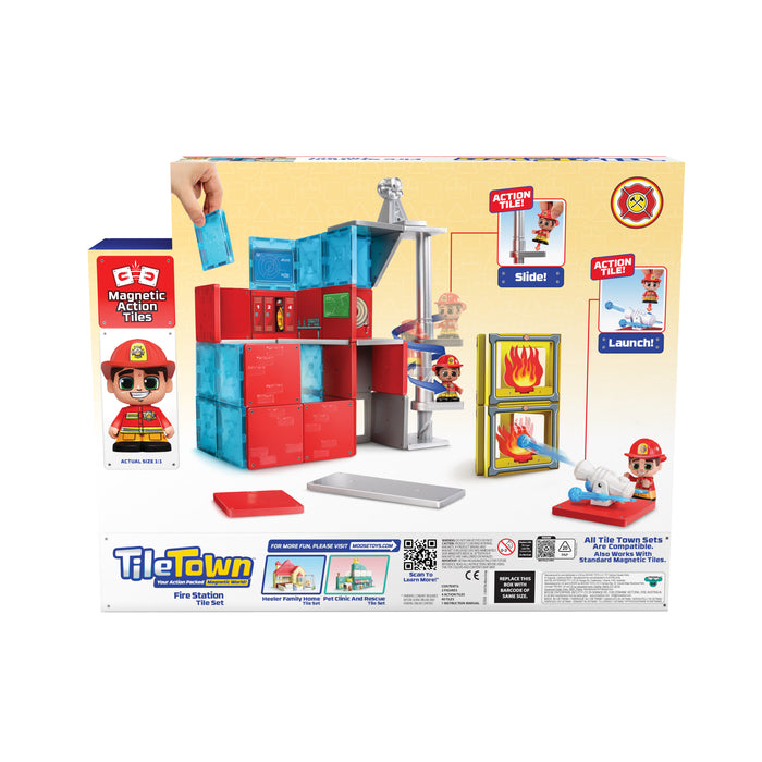 The image shows the back of the Moose Toys Tile Town Fire Station Tile Set box by Moose Toys, highlighting magnetic tiles, firefighter figures, a sliding pole, launching action features, instructions, and vibrant graphics.