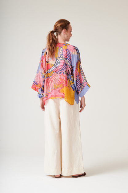 Crane Periwinkle kimono by One Hundred Stars in a premium modal-cupro blend. Lightweight, fluid and perfect for layering over dresses or tops. Shop at Dotique.